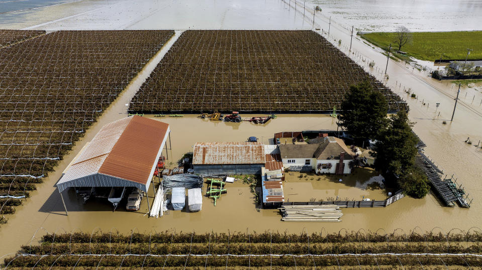 Floodwaters surround a home in the community of Pajaro in Monterey County, Calif., on Monday, March 13, 2023. (AP Photo/Noah Berger)