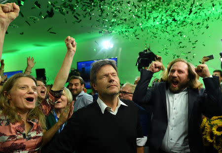 Leaders of the German Green party (Die Gruenen), Robert Habeck and Anton Hofreiter react after the announcement of first exit polls in the Bavarian state elections in Munich, Germany, October 14, 2018. REUTERS/Andreas Gebert