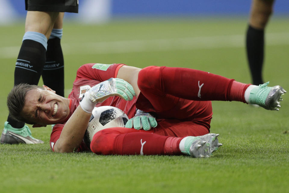 <p>Uruguay goalkeeper Fernando Muslera grimaces during the group A match against Saudi Arabia </p>