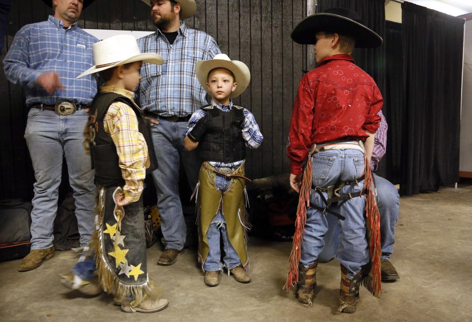 Mini bull riding competitors Avery Speck, Gage Stimpson and Ryan Grace talk before competing at the 108th National Western Stock Show in Denver