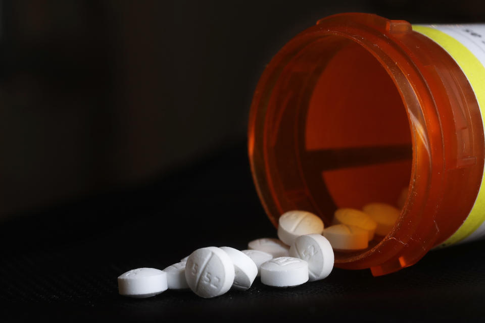 FILE - An arrangement of Oxycodone pills sit next to a bottle in New York on Aug. 29, 2018. A long-awaited review of prescription opioid medications, including their risks and contribution to the U.S. overdose epidemic, is still underway at the Food and Drug Administration, the agency's commissioner said Tuesday, Aug. 30, 2022. (AP Photo/Mark Lennihan, File)