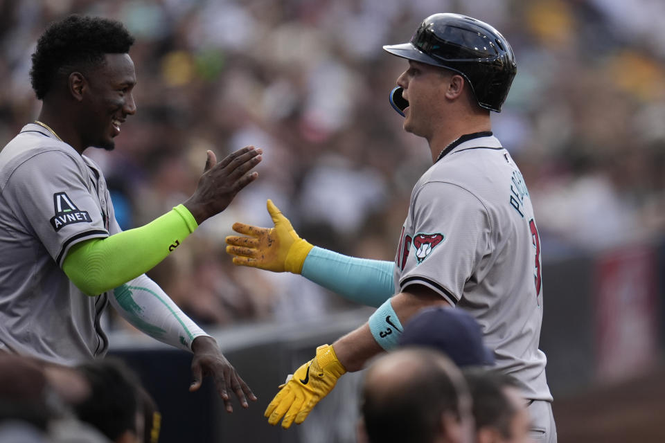 Arizona Diamondbacks' Joc Pederson, right, celebrates with teammate Geraldo Perdomo after hitting a two-run home run during the first inning of a baseball game against the San Diego Padres, Friday, July 5, 2024, in San Diego. (AP Photo/Gregory Bull)