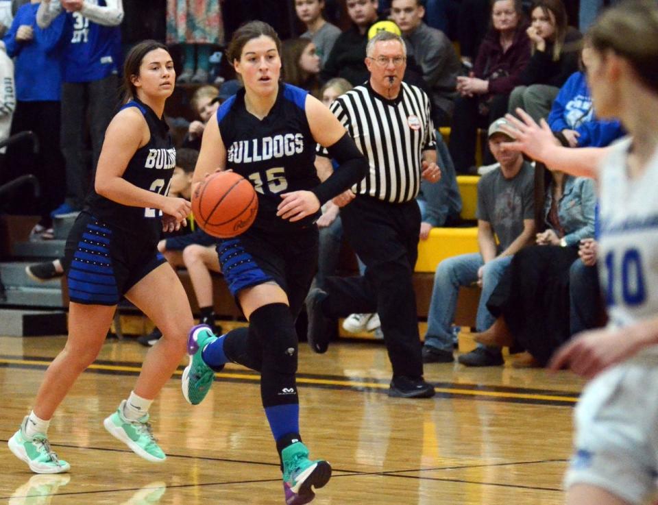 Inland Lakes senior Natalie Wandrie pushes the ball down the court during the first half of Thursday's game, with fellow senior Ryann Clancy behind.