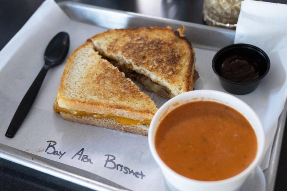 The Bay Area grilled cheese sandwich is served with tomato soup at the Shift Coffee House on Wednesday, May 29, 2024 in North Sacramento.  Owner Mike Hollis said his inspiration for the restaurant came from his love of making grilled cheese sandwiches with his dinner leftovers.