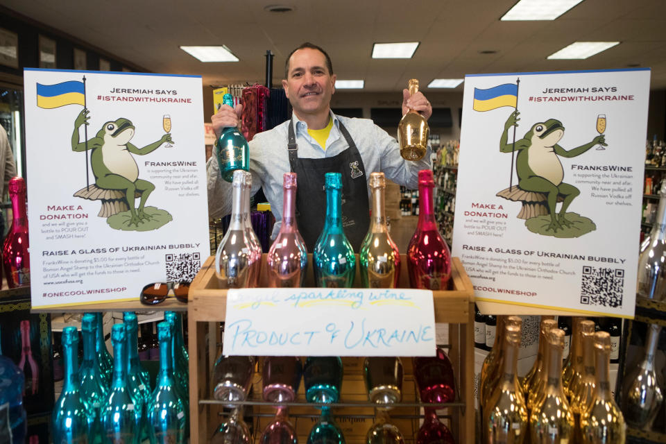 Frank'sWine owner Frank Pagliaro will co-host the 'Last Sips of Summer' outside his business in Wilmington on Sunday. Pagliaro is pictured holding two bottles of Ukrainian sparkling wine Friday, March 4, 2022.