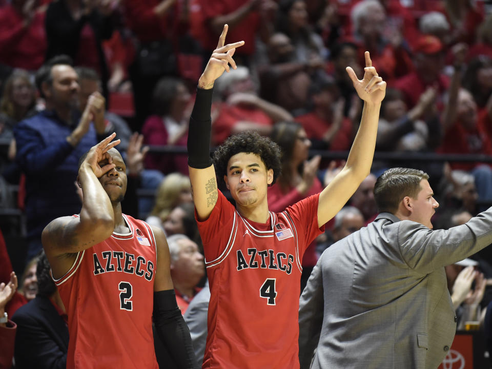San Diego State guard Adam Seiko (2) and guard Trey Pulliam (4) celebrate during the second half of an NCAA college basketball game against Nevada, Saturday, Jan. 18, 2020, in San Diego. (AP Photo/Denis Poroy)