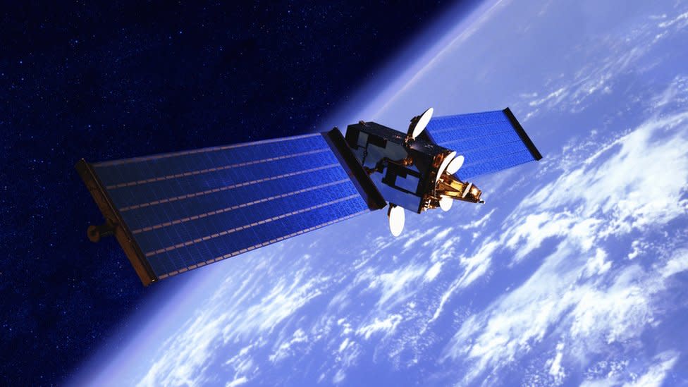 A stock image shows a communications satellite in orbit above the earth