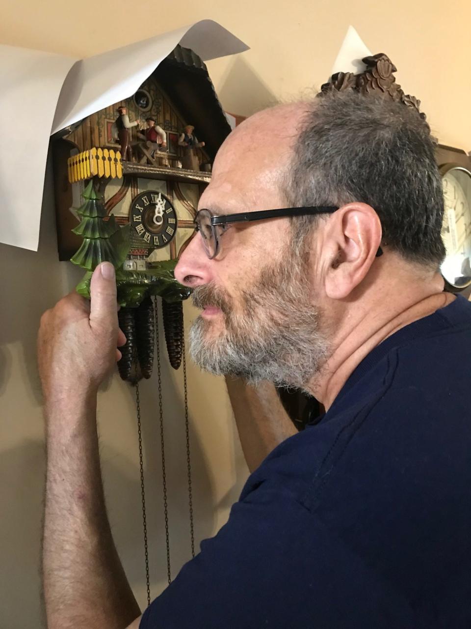 Lancaster Eagle-Gazette columnist Mark Kinsler also repairs clocks like this coo-coo clock he is examining in this archive photo from 2020.