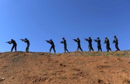 Afghan policemen perform a drill during a graduation ceremony at the Adraskan training centre in Herat province. An Afghan police officer has killed three British soldiers serving with NATO in Afghanistan's Helmand province, the latest in a series of escalating "green on blue" attacks in the decade-long war