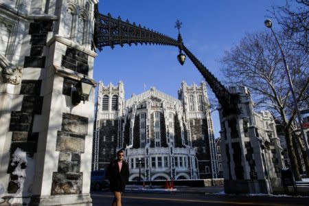 A man walks the campus of the City College of New York in the Harlem borough of New York, U.S., December 16, 2017.  REUTERS/Eduardo Munoz