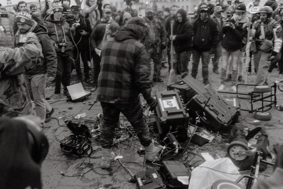 Pro-Trump rioters vandalize equipment that belongs to Associated Press journalists outside the Capitol.<span class="copyright">Christopher Lee for TIME</span>