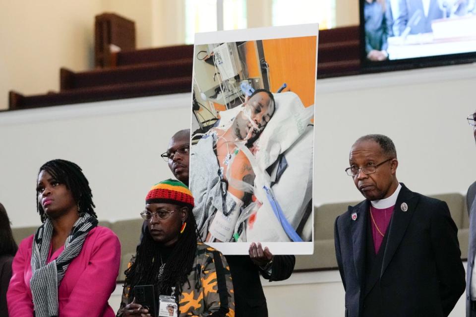 Family members and supporters hold a photograph of Tyre Nichols at a news conference (AP)