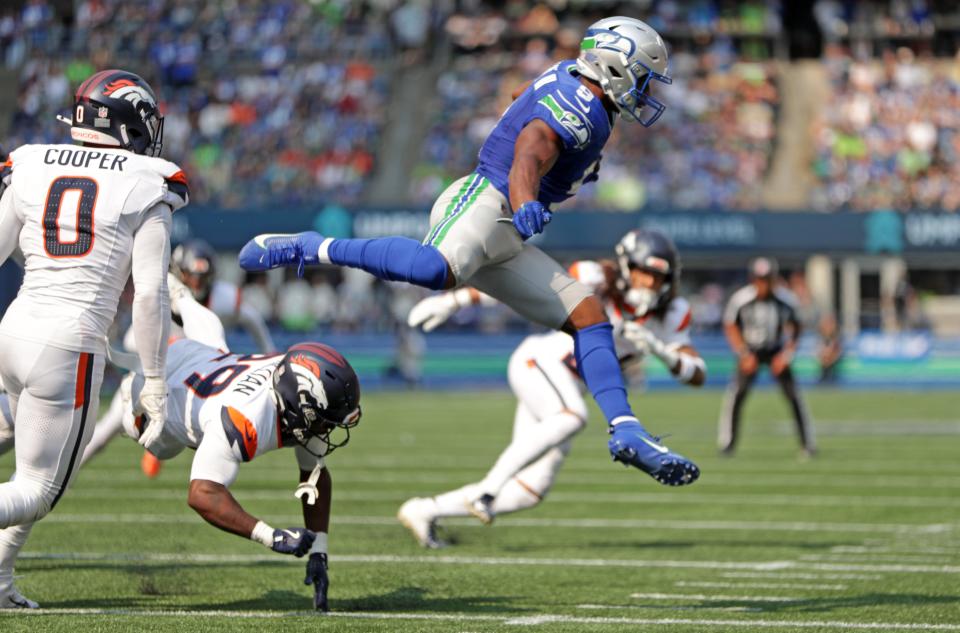 SEATTLE, WASHINGTON - SEPTEMBER 08: Kenneth Walker III #9 of the Seattle Seahawks hurdles Ja'Quan McMillian #29 of the Denver Broncos during the third quarter at Lumen Field on September 08, 2024 in Seattle, Washington. (Photo by Rio Giancarlo/Getty Images)