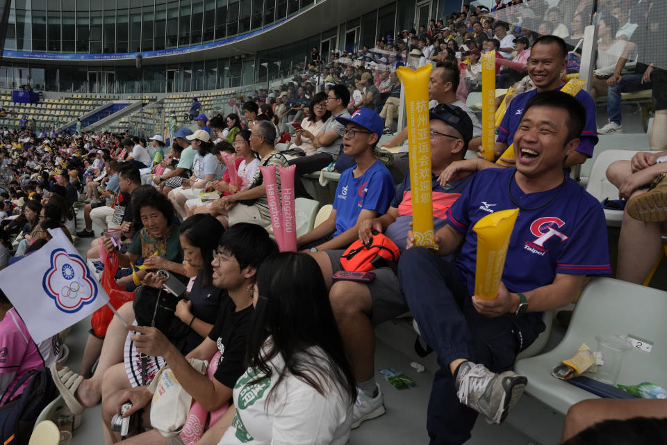 Taiwanese supporters cheer for the Taiwan baseball team during a stage group round B Baseball Men game against Hong Kong for the 19th Asian Games in Hangzhou, China on Tuesday, Oct. 3, 2023. At the Asian Games China has been going out of its way to be welcoming to the Taiwanese athletes, as it pursues a two-pronged strategy with the goal of taking over the island, which involves both wooing its people while threatening it militarily. (AP Photo/Ng Han Guan)