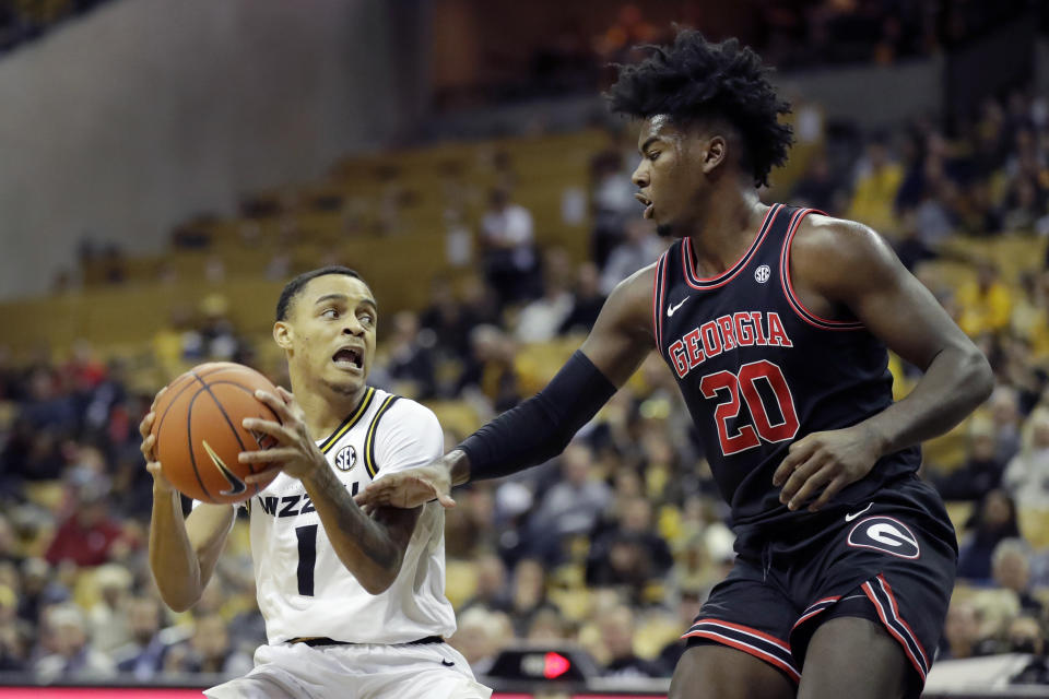 Missouri's Xavier Pinson (1) heads to the basket as Georgia's Rayshaun Hammonds (20) defends during the second half of an NCAA college basketball game Tuesday, Jan. 28, 2020, in Columbia, Mo. Missouri won 72-69. (AP Photo/Jeff Roberson)