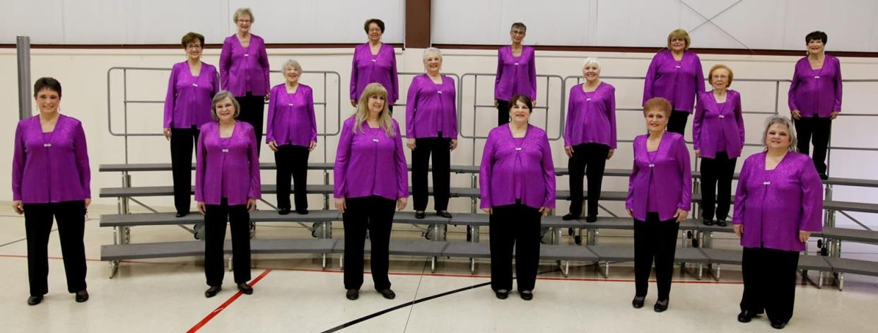 River Raisin Chorus members are shown in performance mode. Many members, including current president Sue Gruber, have been members for decades; Gruber has been a member for 35 years.