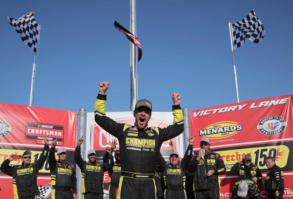 Grant Enfingerand his GMS Racing crew celebrate in victory lane after winning the NASCAR Craftsman Truck Series Clean Harbors 175 on Sunday at the Milwaukee Mile.