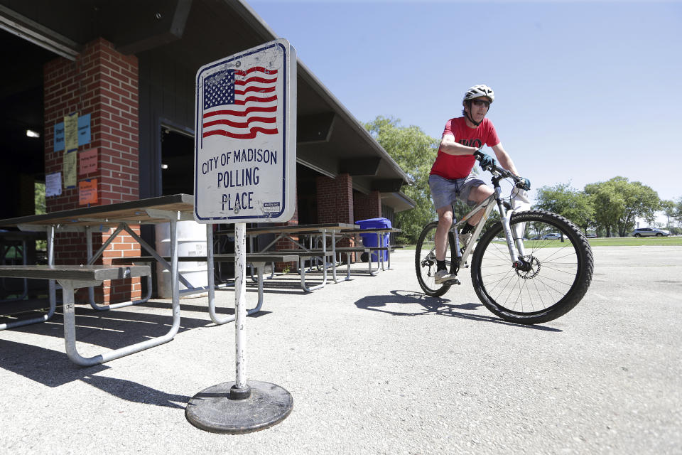 Jeff Durbin rides away from his polling location at the Vilas Park Shelter after voting in Madison, Wis., Tuesday, Aug. 9, 2022. (Kayla Wolf/Wisconsin State Journal via AP)