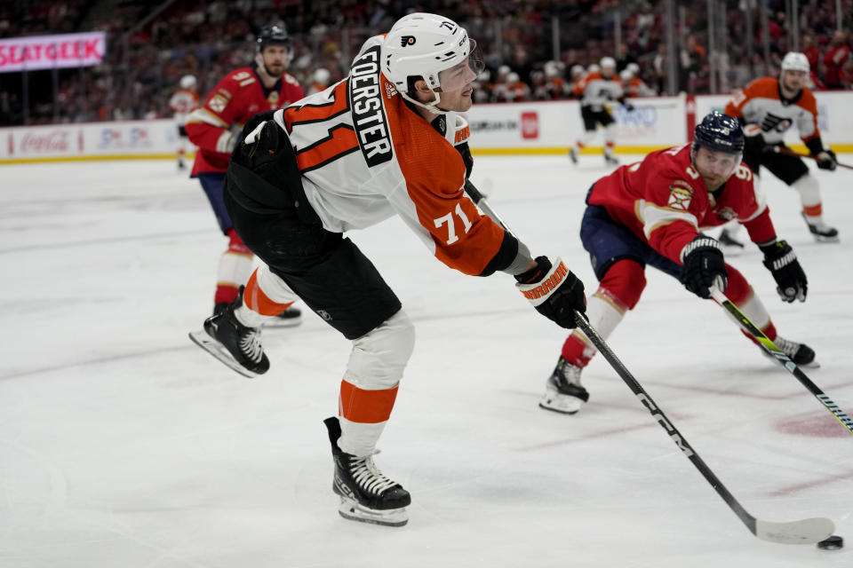 Philadelphia Flyers right wing Tyson Foerster (71) attempts a shot at the goal as Florida Panthers defenseman Oliver Ekman-Larsson (91) defends during the first period of an NHL hockey game, Thursday, March 7, 2024, in Sunrise, Fla. (AP Photo/Lynne Sladky)