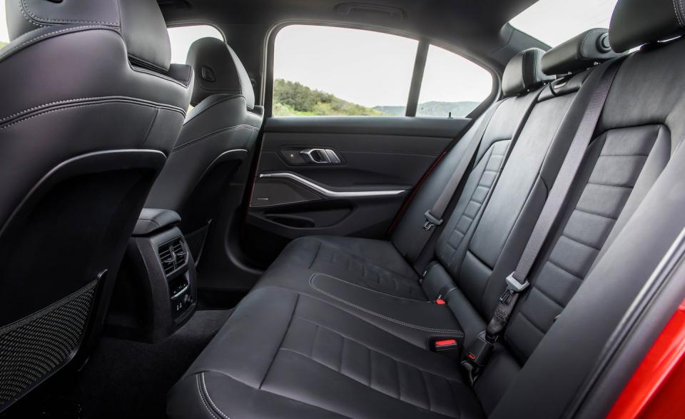 <p>The 330i's middle rear-seat passenger may grumble for having to straddle the prominent center tunnel, but three riders will find livable comfort in the 3's aft quarters. </p>