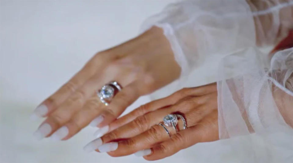 Close up shot of identical twins Anna and Lucy DeCinque's hands wearing matching diamond engagement rings