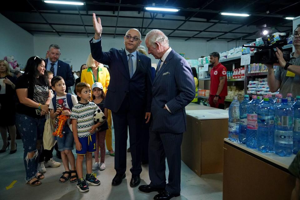 Prince Charles, Prince of Wales (right) with Dr Raed Arafat, State Secretary for Emergency Situatoins and Vice President of the Red Cross, during his visit to the Ukrainian refugee centre on May 25, 2022 in Bucharest, Romania.