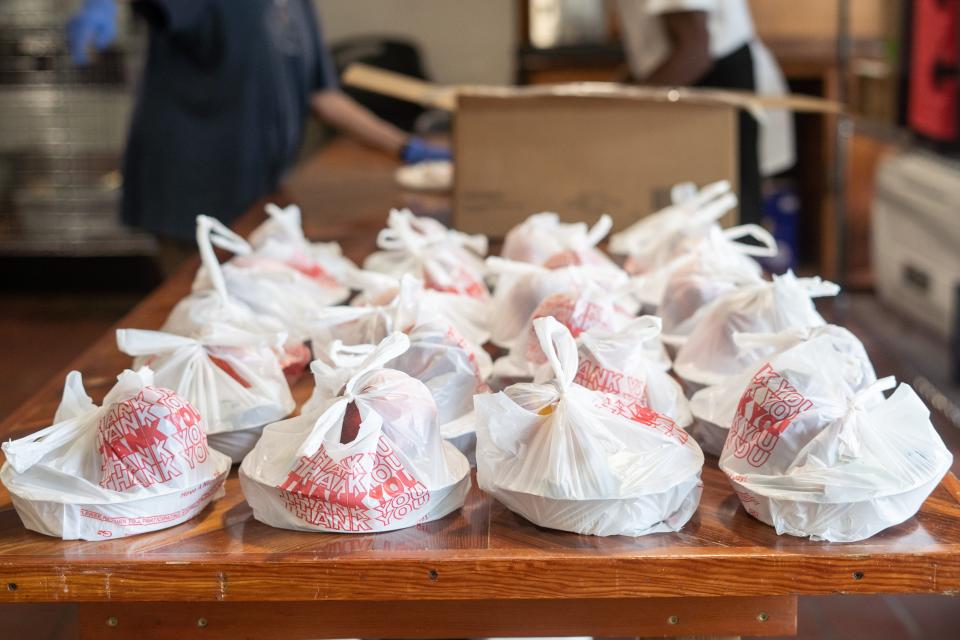 Volunteers pack meals inside of the kitchen in the Southside Kitchen on August 16, 2022.