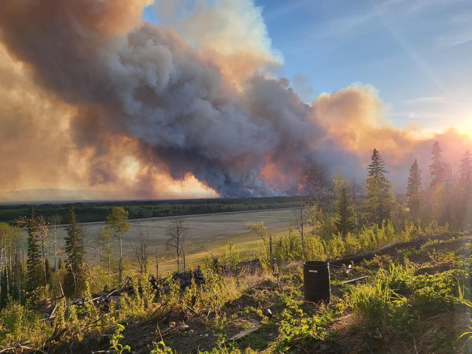 FORT NELSON, BRITISH COLUMBIA, CANADA - MAY 14: Smoke rises after fire erupts in Western Canada on May 14, 2024. Wildfires in Western Canada prompted thousands to flee their homes, while 66,000 were on standby to evacuate as a fast-moving blaze threatened another community Saturday. A growing wildfire moved relentlessly toward Fort Nelson, British Columbia (B.C.), resulting in officials ordering more than 3,000 to leave their homes in Fort Nelson and nearby Fort Nelson First Nation.Within five hours, the fire had grown to 8 square kilometers. (3 square miles) from a modest half square kilometer.Tinder dry conditions and flames fanned by powerful winds caused the wildfire to spread and prompted the evacuation order, which was issued at 7.30 p.m. (Photo by Cheyenne Berreault/Anadolu via Getty Images) climate fears