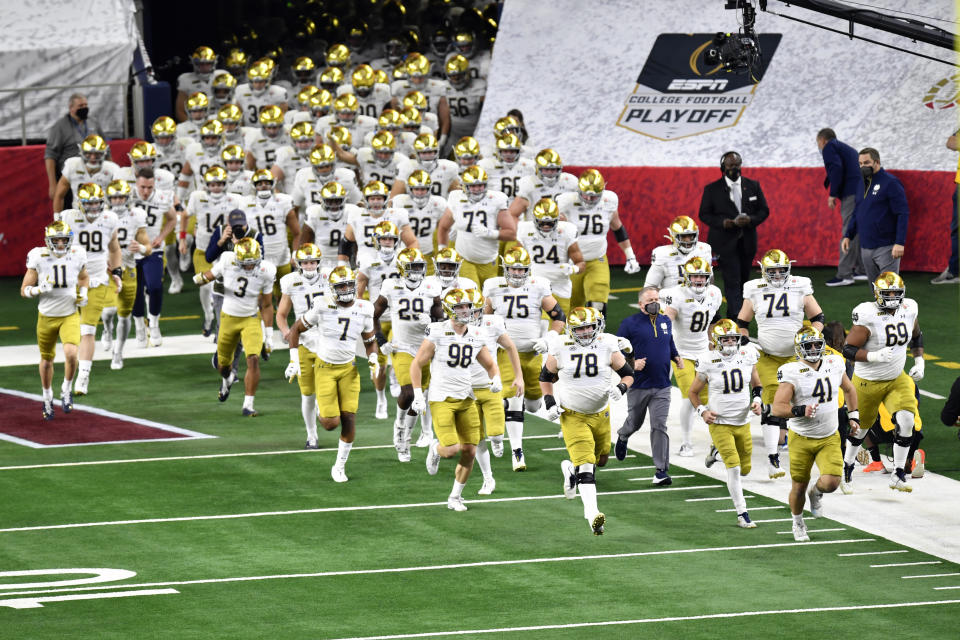 ARLINGTON, TEXAS - JANUARY 01: The Notre Dame Fighting Irish run on the field during player introductions before the College Football Playoff Semifinal at the Rose Bowl football game against the Alabama Crimson Tide at AT&T Stadium on January 01, 2021 in Arlington, Texas. The Alabama Crimson Tide defeated the Notre Dame Fighting Irish 31-14. (Photo by Alika Jenner/Getty Images)