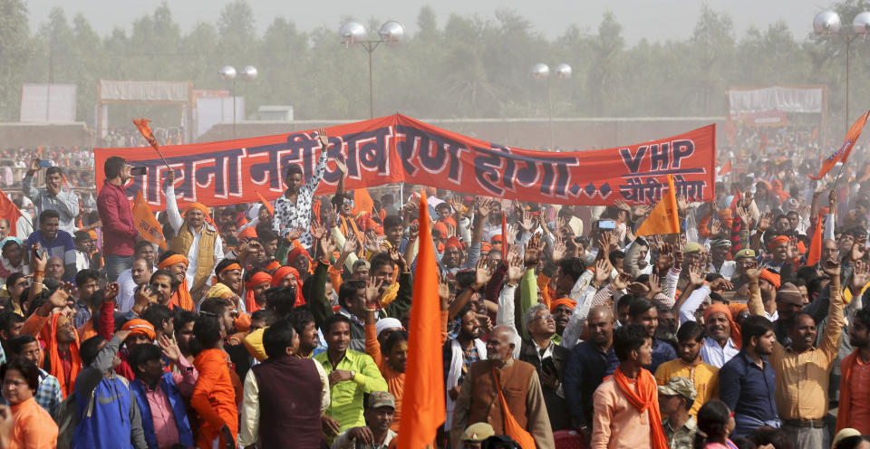 Supporters of Vishwa Hindu Parishad or World Hindu Council gather for a rally to demand the construction of a Ram temple in Ayodhya, India, Sunday, Nov.25, 2018. Tens of thousands of Hindus gathered in the northern Indian city renewing calls to build a Hindu temple on a site where a mosque was attacked and demolished in 1992, sparking deadly Hindu-Muslim violence. Banner in Hindi reads, " No more requests, now it will be battle"(AP Photo)