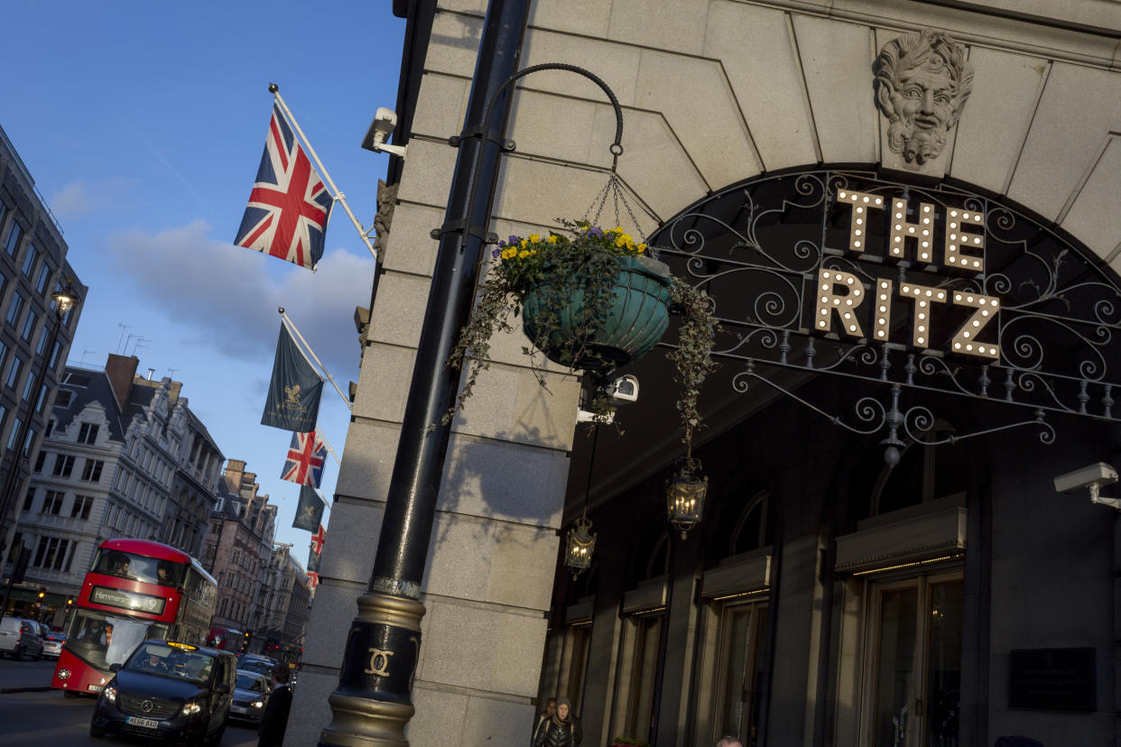 The entrance of the arcade outside The Ritz with Union Jack flags, a Routemaster bus and distant architecture on Piccadilly, on 7th February 2018, in London, England. (Photo by Richard Baker / In Pictures via Getty Images Images)