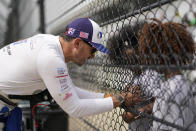 Graham Rahal signs an autograph during practice for the Indianapolis 500 auto race at Indianapolis Motor Speedway, Thursday, May 19, 2022, in Indianapolis. (AP Photo/Darron Cummings)