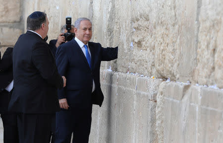 Israeli Prime Minister Benjamin Netanyahu touches the stones of the Western Wall during a visit together with U.S. Secretary of State Mike Pompeo to the site in Jerusalem's Old City March 21, 2019. Abir Sultan/ Pool via REUTERS