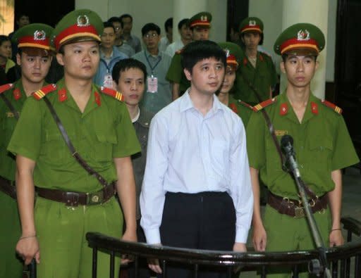 Vu Duc Trung (C, first row), and Le Van Thanh (C, second row), two Vietnamese Falungong practitioners stand trial at Hanoi's People's Court for beaming Falungong-linked radio broadcasts into China, where the movement is banned and labelled an "evil cult". Trung received a three-year sentence and Thanh was sentenced to two years