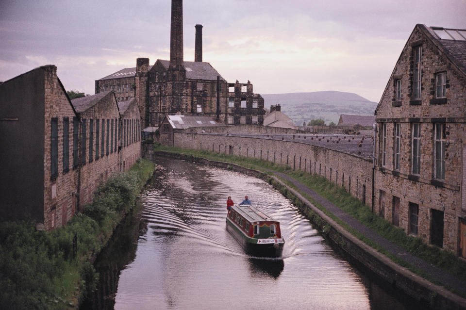 A barge sails along the Leeds and Liverpool canal by Weaver's triangle. (Photo By RDImages/Epics/Getty Images)