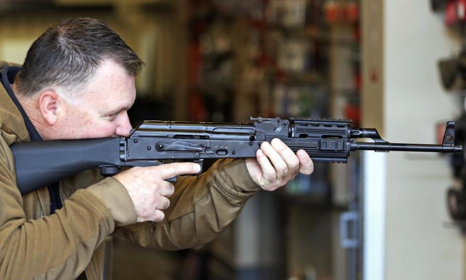 Clark Aposhian, chairman of the Utah Shooting Sports Council, demonstrates how a bump stock works when attached to a semi-automatic rifle on Wednesday in South Jordan, Utah. 