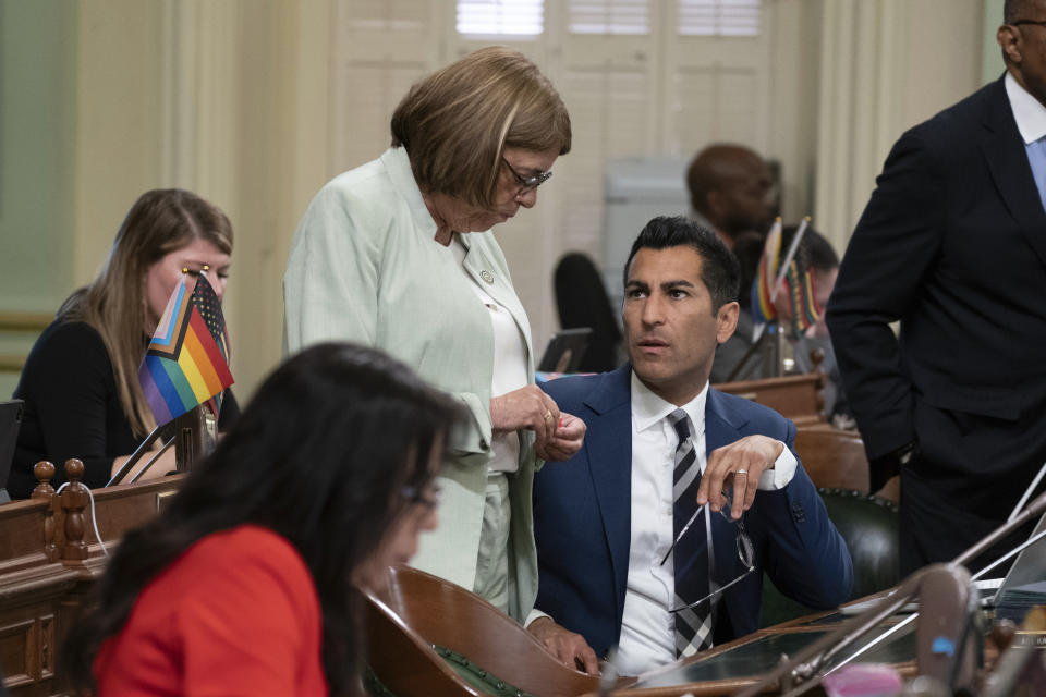 FILE - Assemblywoman Cecilia Aguilar-Curry, D-Winters, talks with Assembly Speaker Robert Rivas, D-Hollister, as lawmakers discuss the state budget at the Capitol in Sacramento, Calif., Tuesday, June 27, 2023. Rivas appoints Aguilar as the new Assembly Speaker Pro Tem after he took over the influential role at the end of June. (AP Photo/Rich Pedroncelli, File)