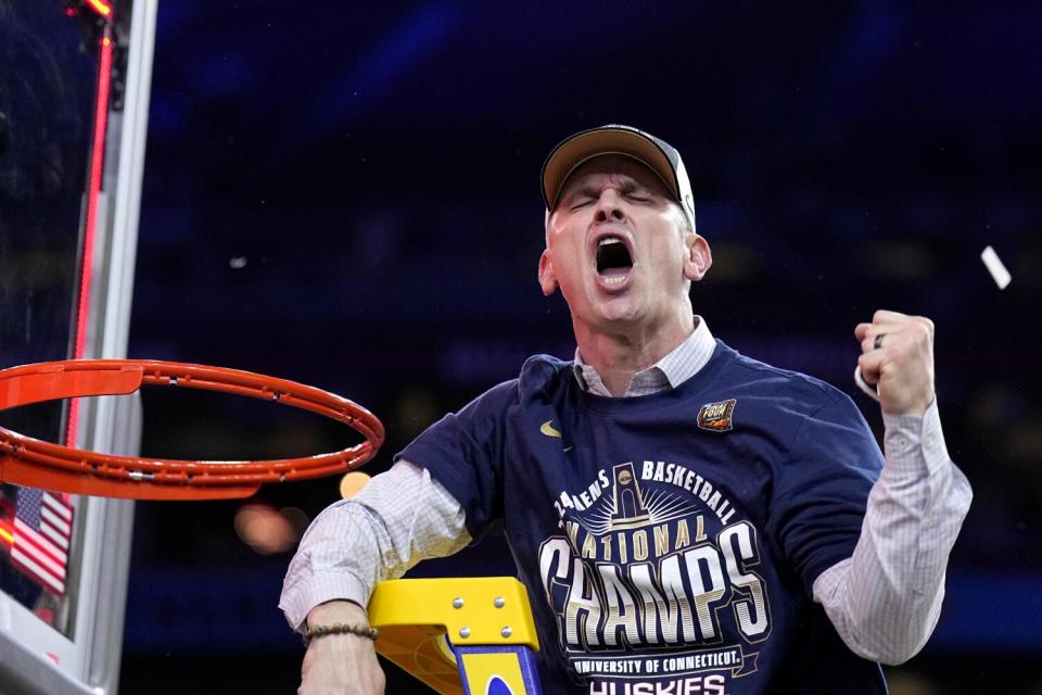 Connecticut coach Dan Hurley celebrates after cutting down the net.