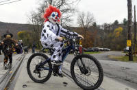 Seth Goodman, of Port Carbon, Pa., and his brother Chase Goodman, back, cross the train tracks on Jackson Street in the annual Port Carbon Halloween Parade in Port Carbon, Pa., on Saturday, Oct. 31, 2020. The parade was sponsored by Port Carbon Citizens Committee and local businesses. (Jacqueline Dormer/Republican-Herald via AP)