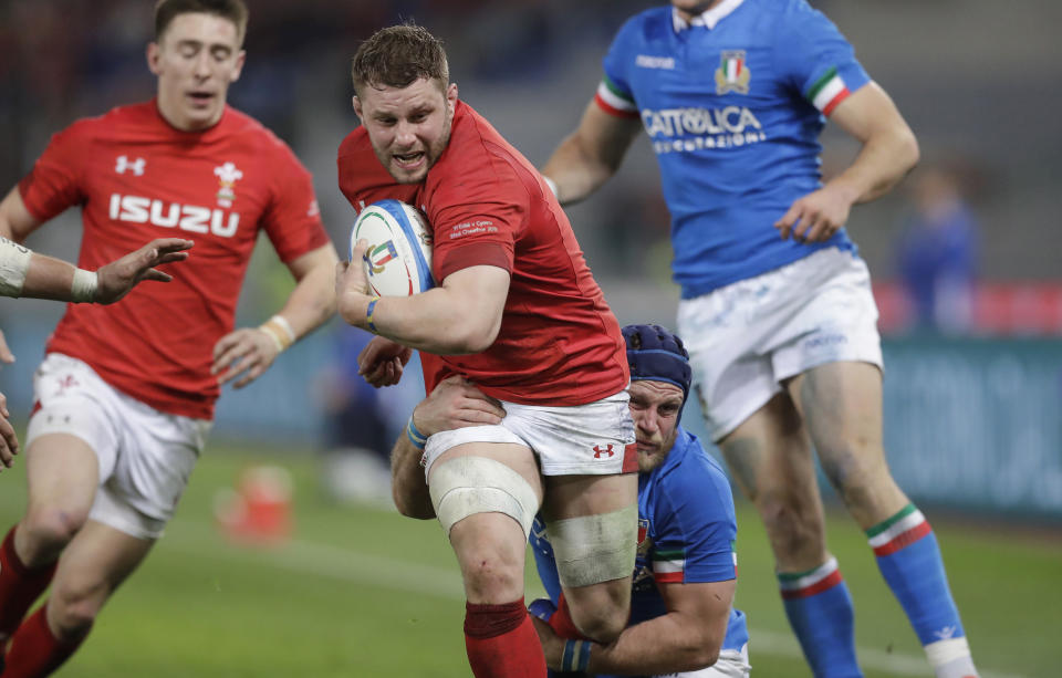 Wales' Thomas Young, left, is tackled by Italy's Luca Bigi during the Six Nations rugby union international between Italy and Wales, at Rome's Olympic Stadium, Saturday, Feb. 9, 2019. (AP Photo/Andrew Medichini)