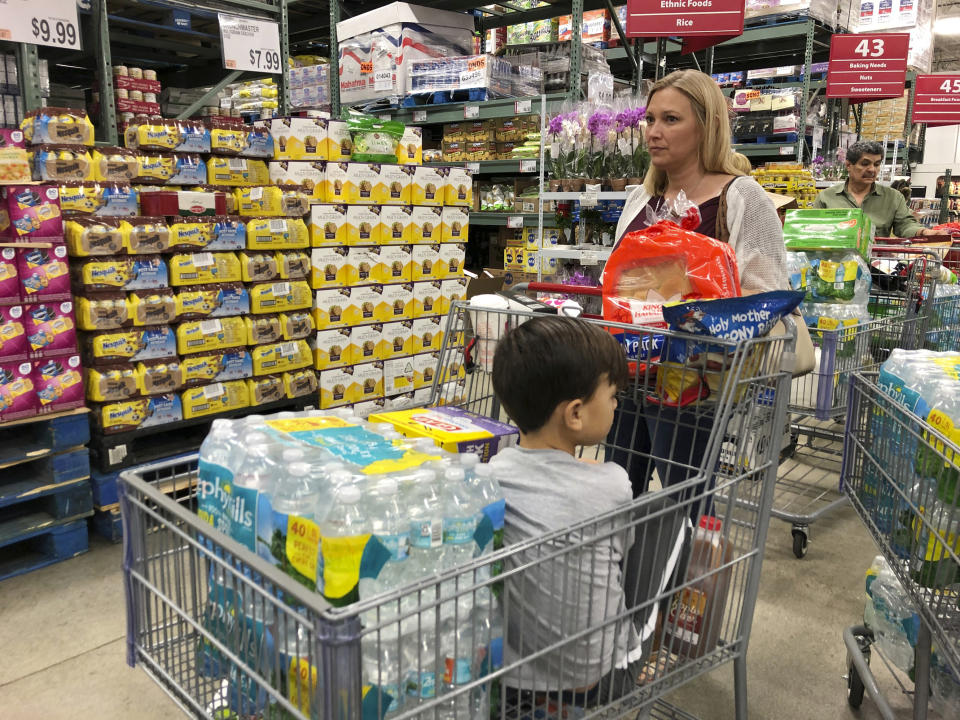 Tiffany Miranda of Miami Springs stands in line with supplies at a BJ's Wholesale Club Thursday, Aug. 29, 2019, in Hialeah, Fla. Miranda has been through five hurricanes and has never evacuated. She says, "you just have to be prepared."The U.S. National Hurricane Center says Dorian could hit the Florida coast over the weekend as a major hurricane. (AP Photo/Marcus Lim)