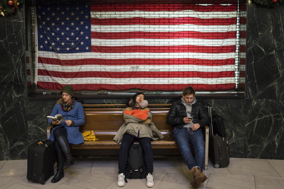 Passengers wait after their flights were delayed at LaGuardia Airport's Terminal A during a winter storm in New York