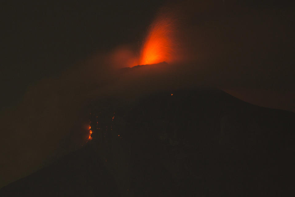 <p>In this image taken with a long exposure, the Volcan de Fuego, or Volcano of Fire, spews molten rock from its crater in Alotenango, Guatemala, June 3, 2018. (Photo: Luis Soto/AP) </p>