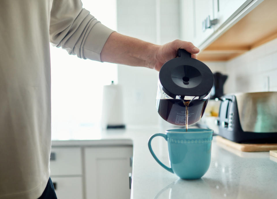 Someone pouring coffee in their kitchen