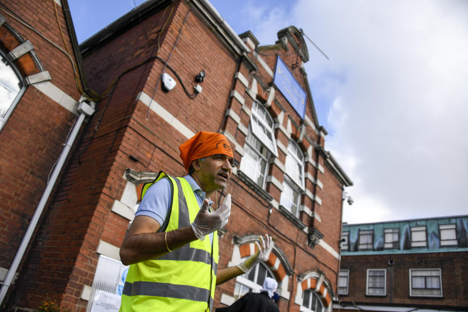 Professor Gurch Randhawa speaks to the media outside the Guru Nanak Gurdwara Sikh temple, on the day the first Vaisakhi Vaccine Clinic is launched, in Luton, England, Sunday, March 21, 2021. (AP Photo/Alberto Pezzali)