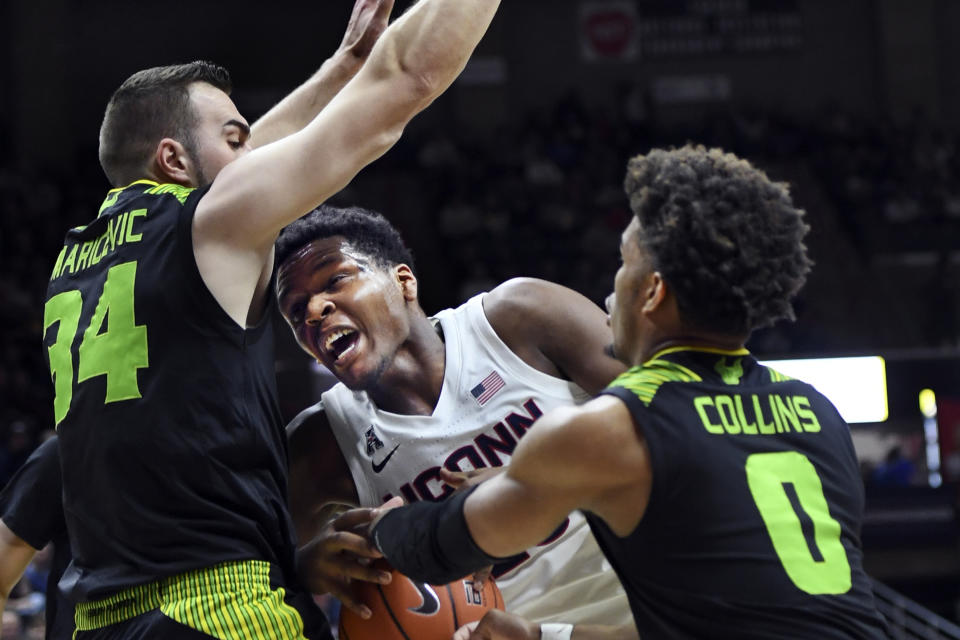 Connecticut's Josh Carlton (25) runs into South Florida's Antun Maricevic (34) during the first half of an NCAA college basketball game Sunday, Feb. 23, 2020, in Storrs, Conn. (AP Photo/Stephen Dunn)