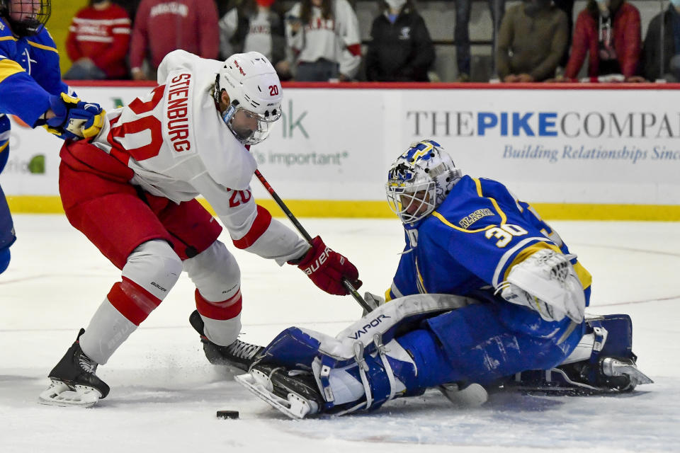 FILE - Alaska Nanooks goalie Gustavs Grigals, right, makes a save against Cornell forward Matt Stienburg during the first period of an NCAA college hockey game on Friday, Oct. 29, 2021 in Ithaca, N.Y. The Nanooks are all about making the most of what they've got. The latest conference shuffle in the sport left them without league affiliation, so they're currently playing as an independent. Which is so much better than not playing at all, a deprivation they were enduring a year ago due to the pandemic. (AP Photo/Adrian Kraus, File)