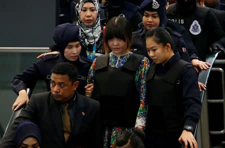 FILE PHOTO: Vietnamese Doan Thi Huong, who is on trial for the killing of Kim Jong Nam, the estranged half-brother of North Korea's leader, is escorted as she revisits the Kuala Lumpur International Airport 2 in Sepang, Malaysia October 24, 2017. REUTERS/Lai Seng Sin