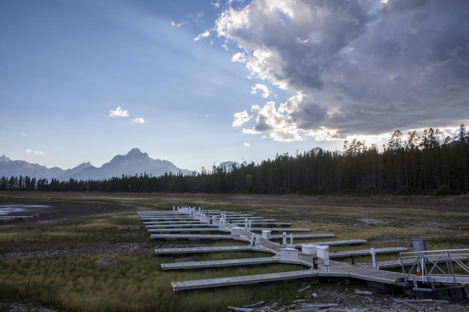 Colter Bay Marina remains closed for the summer due to the low water levels of Jackson Lake on Tuesday, Aug. 23, 2022, at Grand Teton National Park in Moran, Wyo. When officials of the Federal Reserve Bank of Kansas City sought a location for an annual economic symposium in 1981, they chose Jackson Hole, Wyo., for a simple reason: It had fly-fishing. Paul Volcker, the Fed chairman at the time, was known to enjoy the pastime. Now, however, warmer waters in Jackson Lake and the Snake River it empties into have led the Park Service to urge anglers to restrict their fishing to the morning hours. (AP Photo/Amber Baesler)