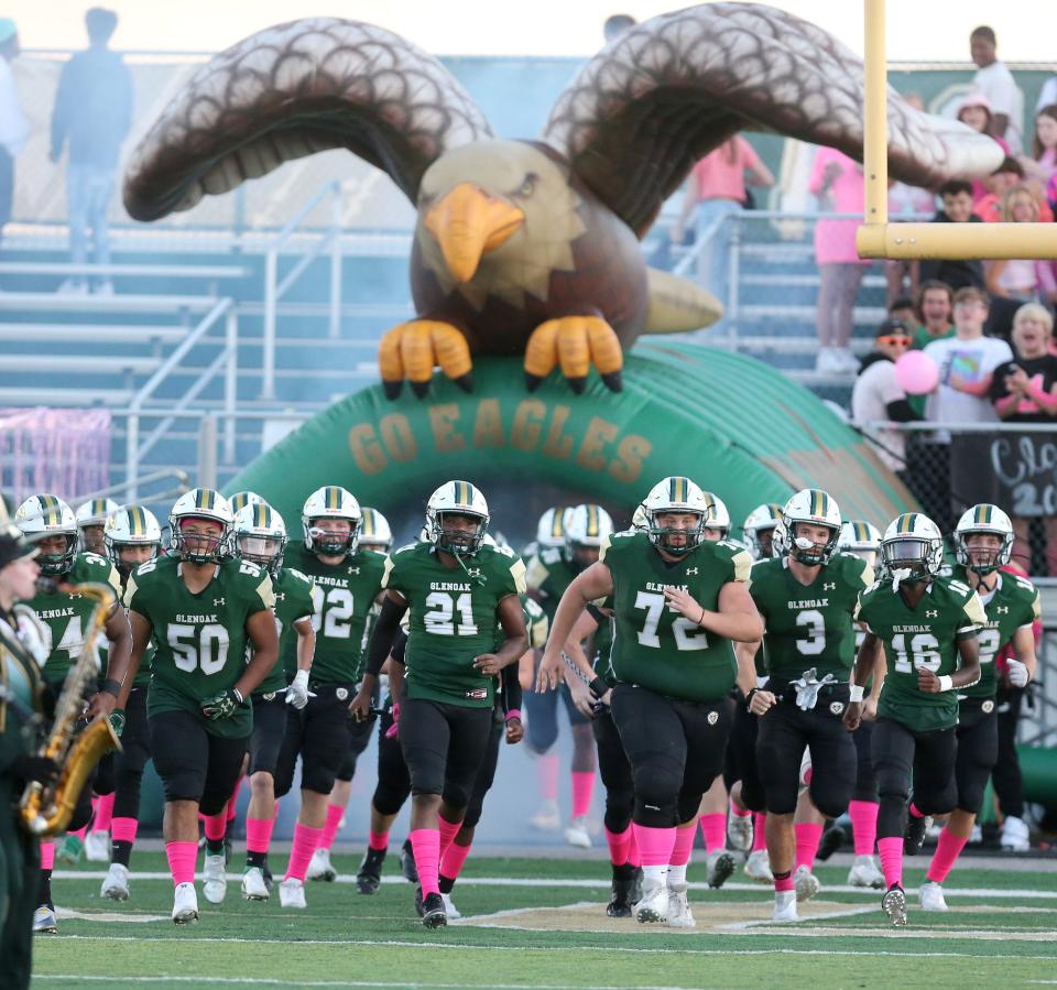 GlenOak football players enter the stadium wearing pink socks prior to their game against Jackson at GlenOak on Friday, Oct. 1, 2021.